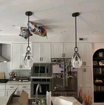 Modern kitchen with pendant lights and white cabinets