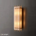 A rectangular alabaster wall sconce with a warm glow, featuring a natural texture and gold accents.