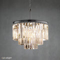 A luxurious multi-layered round chandelier with transparent crystals and a gold-colored metal frame, designed for indoor use