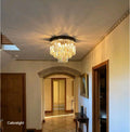 Chandelier hanging in a hallway with 'Calicslight' branding.