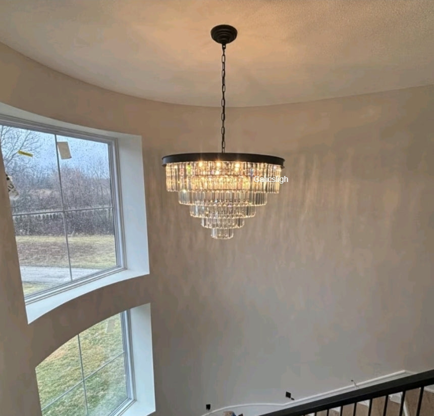 Chandelier hanging in a room with large windows