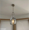 Clear glass pendant light fixture hanging from a ceiling