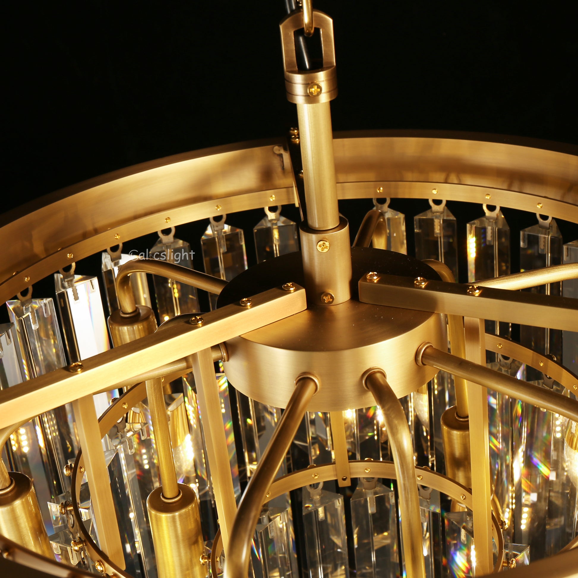 Close-up of a gold chandelier with crystal accents against a dark background